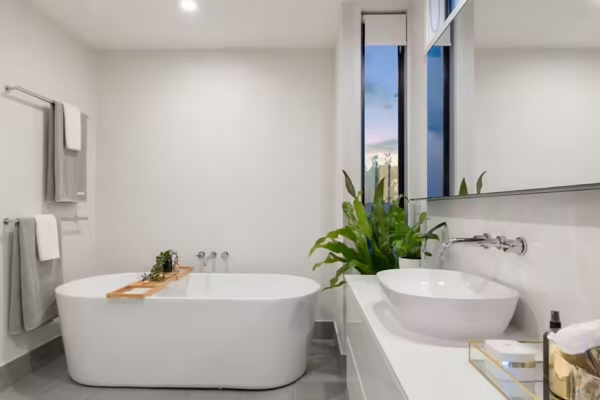 White and Gray bath room with touch of wood and plant for a home to sell